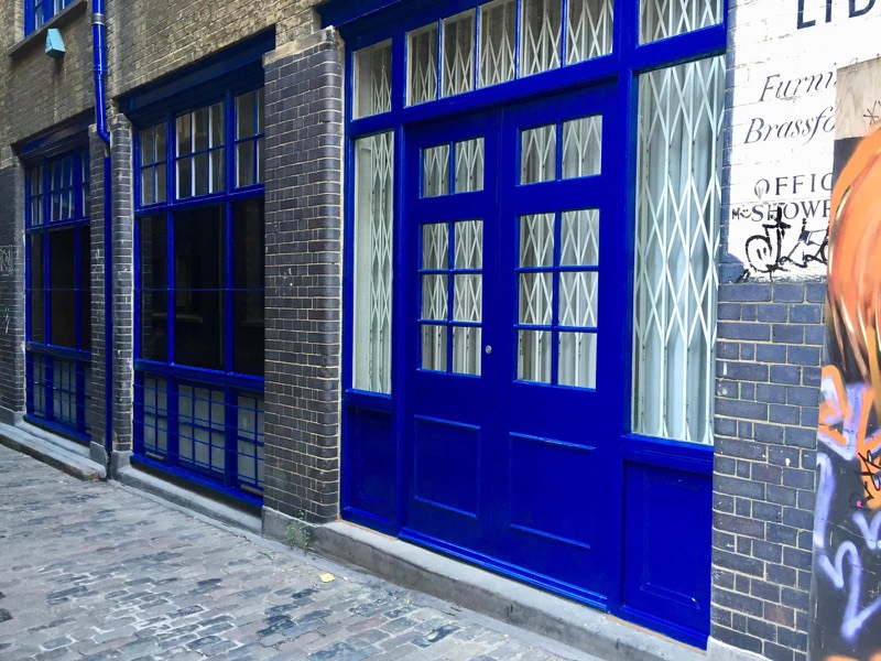 Restored and repainted blue wooden shop front on a London street