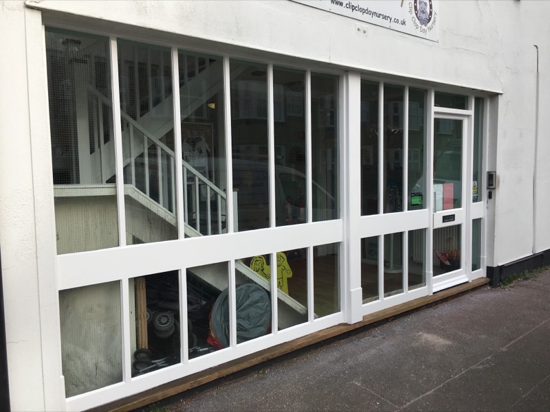 The same shop front repaired and repainted white